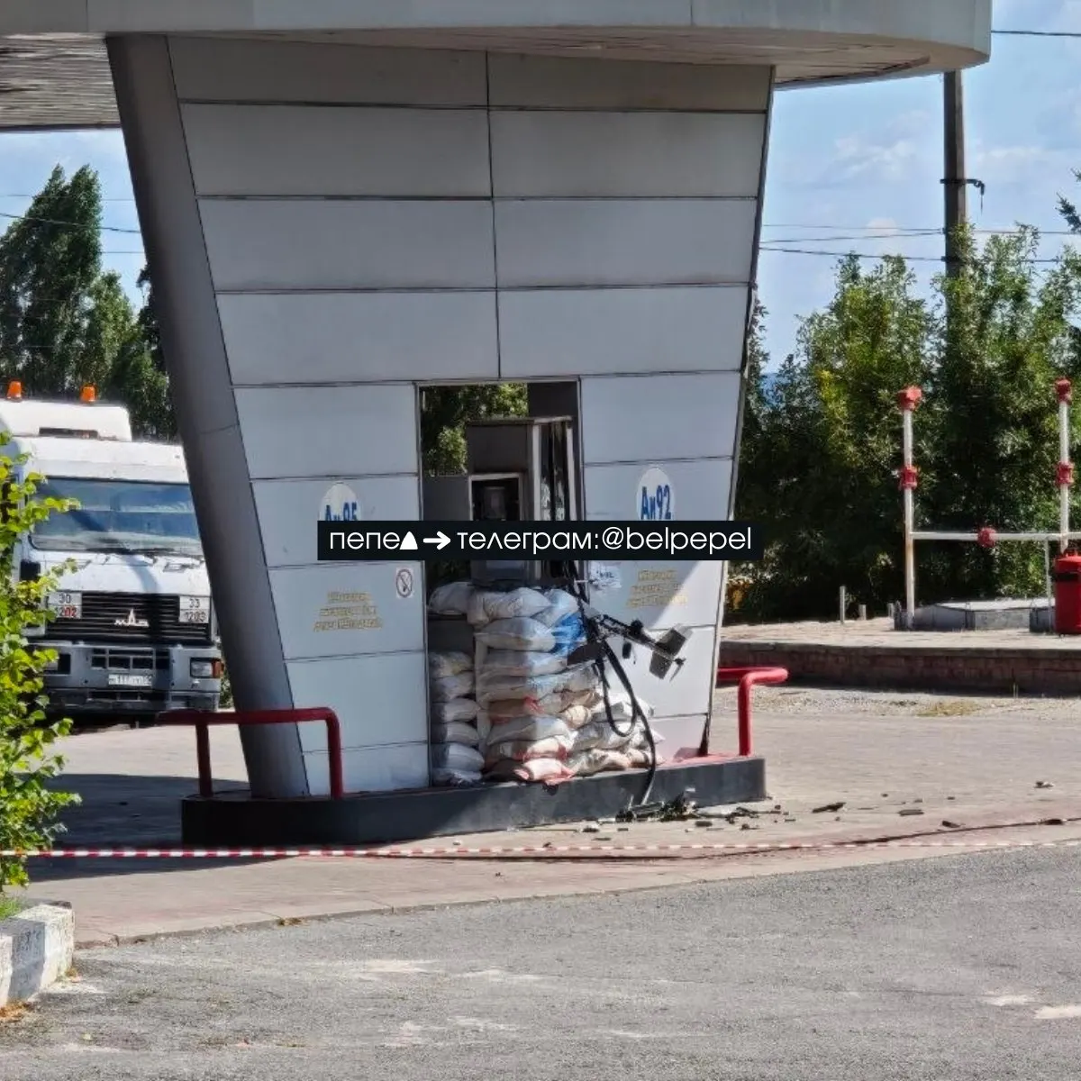 БПЛА ударил по заправке в Белгороде; бесшумный дрон не сдетонировал и застрял в мешках с песком вокруг АЗС.